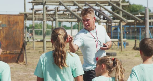 Coach Instructing Group of Children at Outdoor Obstacle Course - Download Free Stock Images Pikwizard.com