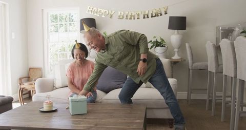 Elderly Couple Joyfully Celebrating Birthday Together at Home