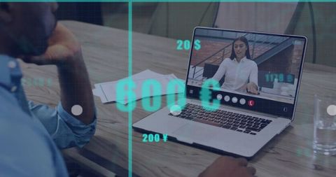 Man sitting using laptop for remote video call with floating currency overlays