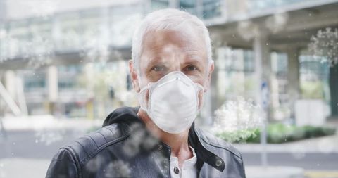 Mature Man Wearing Mask Outdoors with Airborne Particles