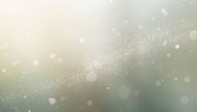 Shimmering particle band creating soft bokeh glow and ethereal light gradient background