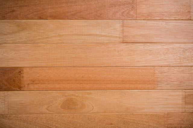 This image showcases a close-up view of a wooden floor with visible natural grain and texture. Ideal for use in interior design projects, home decor inspiration, construction materials, and carpentry-related content. It can also serve as a background for websites, presentations, and promotional materials.