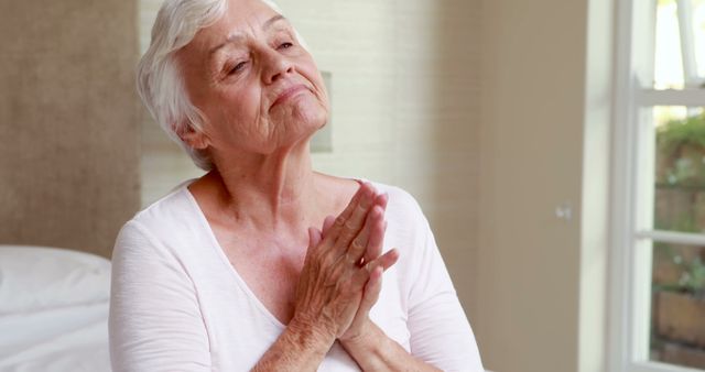 Senior Woman Relaxing Indoors with Hands Clasped - Download Free Stock Photos Pikwizard.com