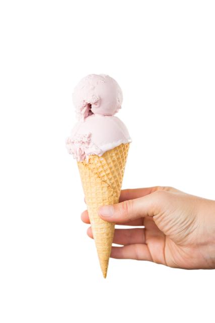 Close-up of hand holding a waffle cone with double scoop strawberry ice cream