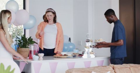 Friends Celebrating Baby Shower with Decorations and Food