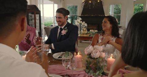 Bride and groom hosting luxurious indoor wedding reception