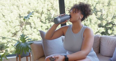 African American Woman Relaxing After Home Workout