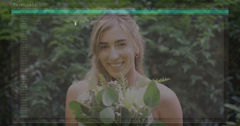 Smiling woman holding bouquet in garden with hud overlay, feminine serene portrait