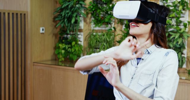 Woman Experiencing Virtual Reality Wearing VR Headset in Office - Download Free Stock Images Pikwizard.com