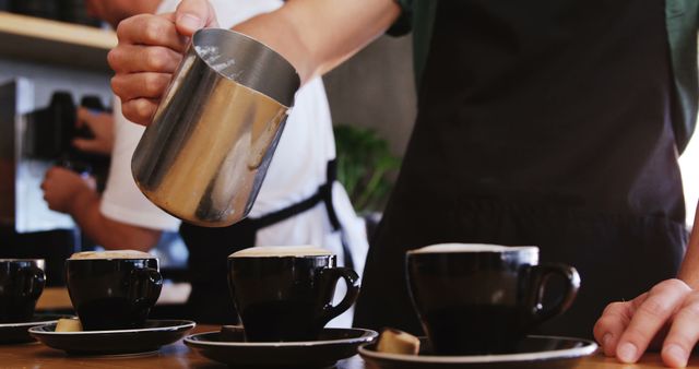 Barista Pouring Frothy Milk into Coffee Cups in Cafe - Download Free Stock Images Pikwizard.com