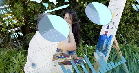 Senior and middle-aged women hugging while painting in backyard garden with ar charts