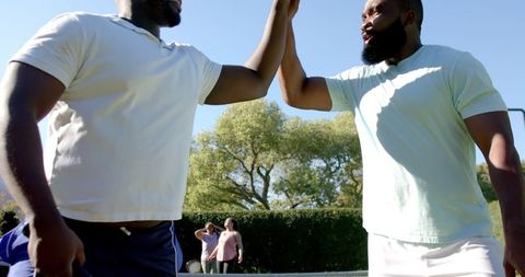 Diverse Friends Connecting Outdoors in Sunny Park Setting