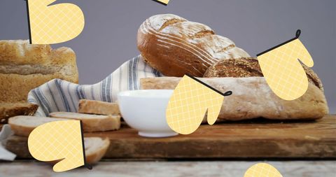 Artistic Falling Yellow Glove Cutouts Over Fresh Artisan Bread