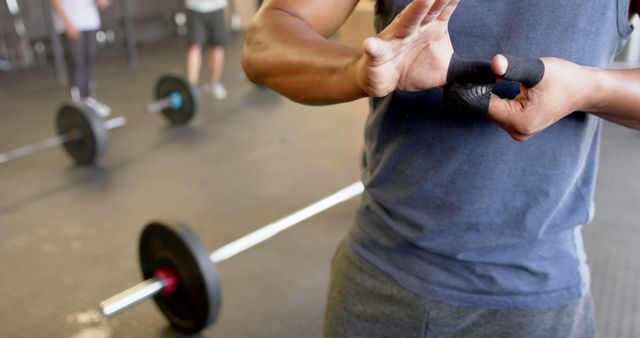 Man Wrapping Hands with Wrist Bands in Gym - Download Free Stock Images Pikwizard.com