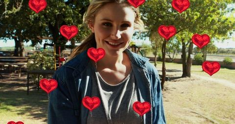 Happy Mother in Park with Heart Decorations Celebrating Family Day