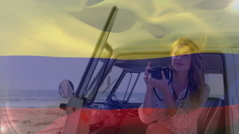 Woman Holding Camera with Colombian Flag Overlay by Beach