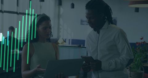 Diverse Colleagues Analyzing Financial Data in Modern Office Setting