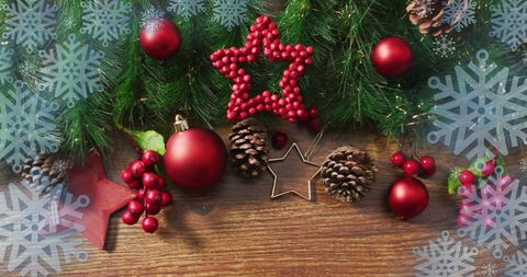 Festive Christmas Decorations with Red Ornaments on Wooden Table - Download Free Stock Images Pikwizard.com