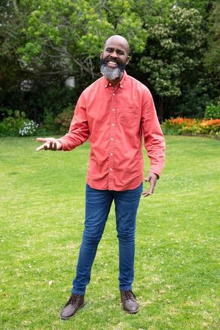 Smiling man enjoying outdoor garden in casual dress