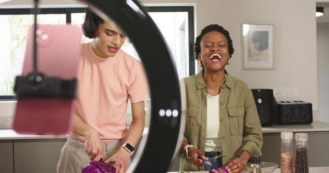 Young Friends Creating Cooking Content While Chopping Purple Cabbage in Modern Kitchen