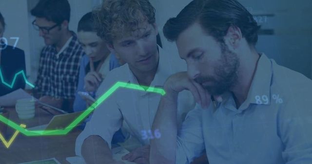 Business analysts examining reports in modern conference room