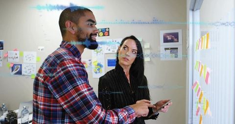 Collaborating on product design using sticky notes and smartphone in modern office