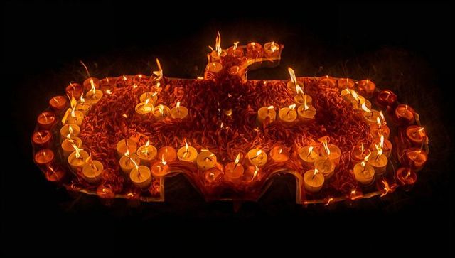 Bat silhouette with candles and marigold petals for nocturnal decor