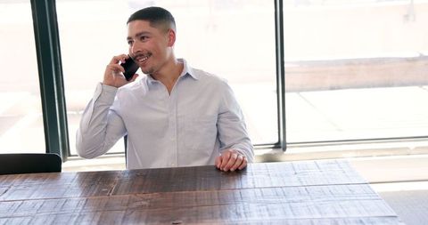 Professional Speaking on Phone in Modern Office Setting