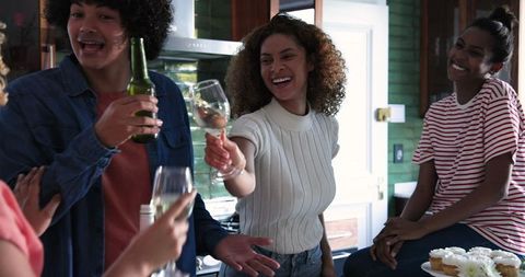 Diverse Friends Celebrating with Toast in Bright Kitchen