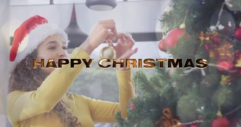 Young woman in santa hat decorating cozy living room christmas tree with gold baubles
