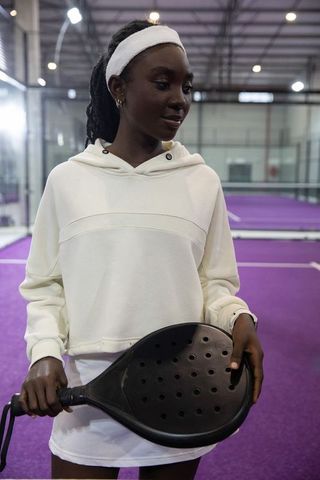 Young african american athlete holding padel racket on indoor purple court