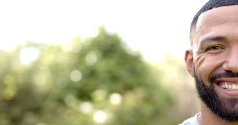 Half Portrait of Happy Man Smiling in Sunny Garden