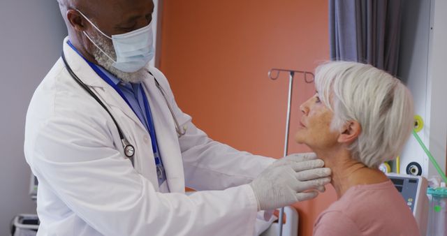 Medical professional wearing a white coat conducting a routine health examination on a senior patient in a hospital setting. Suitable for use in healthcare advertisements, medical blogs, senior health articles, and hospital brochures.