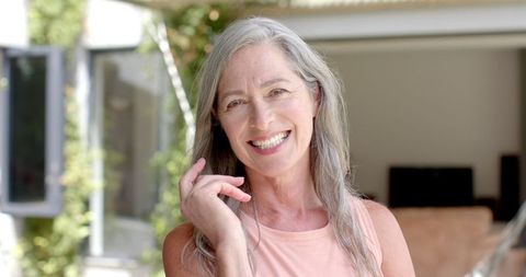 Happy senior woman with grey hair and natural smile