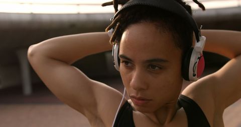 Focused Woman Exercising with Music Headphones in Urban Setting - Download Free Stock Images Pikwizard.com
