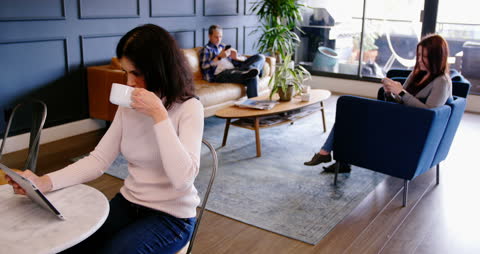 Modern Office Lounge with Professionals Relaxing and Working