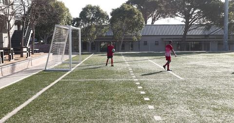 Youth soccer players celebrating goal with ref on field