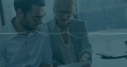 Business Professionals Analyzing Digital Data with Technology Interface