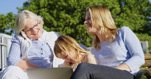 Multi-generational family enjoying outdoor activity with laptop - Download Free Stock Images Pikwizard.com