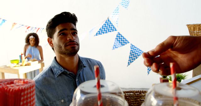 Man Ordering Drink at Outdoor Party with Decorations - Download Free Stock Images Pikwizard.com