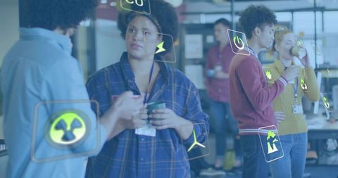 Diverse team collaborating on sustainability concepts in coworking with ar icons