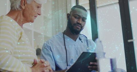 Clinician reviewing digital health records with senior patient and holographic data overlay