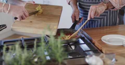 Middle Aged Couple Cooking Together in Kitchen