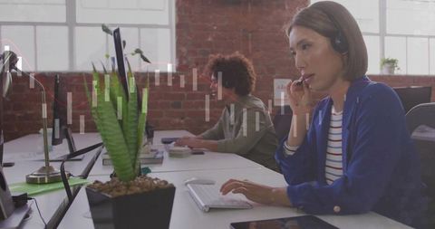 Focused Businesswoman in Office Communicating via Headset