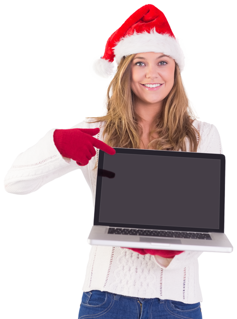 Smiling festive woman pointing to blank screen laptop wearing Santa hat - Download Free Stock Videos Pikwizard.com