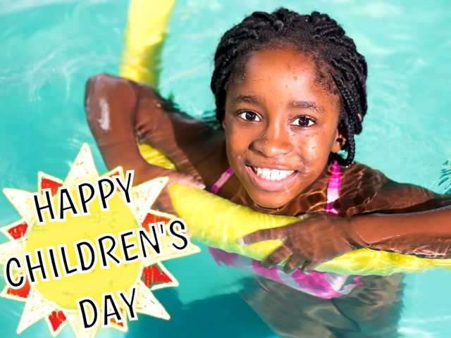 Young African American girl swimming in outdoor pool holding a yellow noodle, celebrating Children's Day with a big smile. Ideal for promotions related to summer activities, children's events, celebrations, and family fun days.