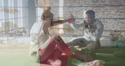 Partner training giving high-five during turf core workout with kettlebell motivation