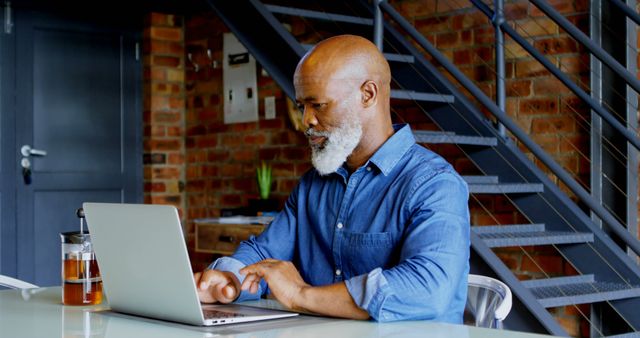 Focused Mature African American Man Working on Laptop in Modern Office - Download Free Stock Images Pikwizard.com