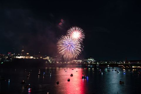 Spectacular Firework Display Over River at Night