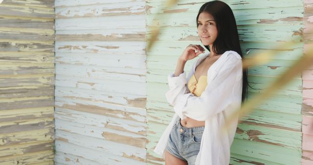 Young Woman Posing in Casual Beachwear Against Weathered Wooden Wall - Download Free Stock Images Pikwizard.com